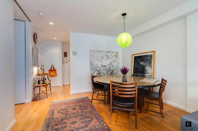 dining room with recessed lighting, baseboards, and light wood-style floors