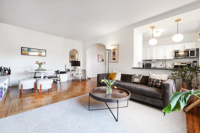 living area featuring arched walkways