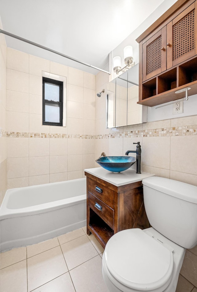 273 Bennett Ave Unit 5-G, New York City, NY 10040 - full bathroom featuring toilet, tile patterned floors, tile walls, vanity, and shower / tub combination