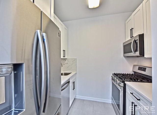 99 John St Unit 2504, New York City, NY 10038 - kitchen with appliances with stainless steel finishes, light countertops, light tile patterned floors, and white cabinets