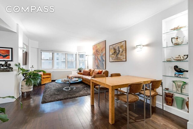 dining space with wood-type flooring
