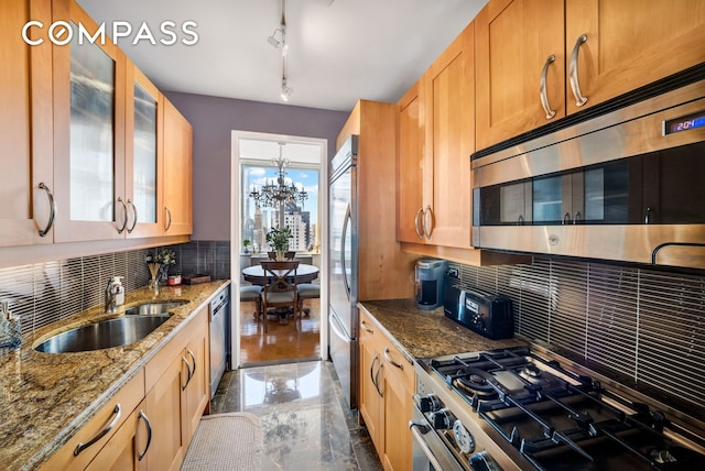 401 E 60th St Unit 35B, New York City, NY 10022 - kitchen with stainless steel appliances, tasteful backsplash, glass insert cabinets, stone countertops, and track lighting