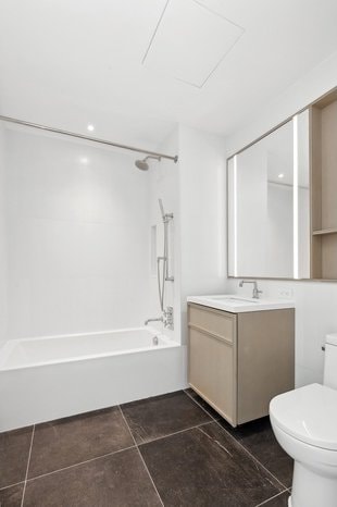 bathroom featuring toilet,  shower combination, tile patterned floors, and vanity