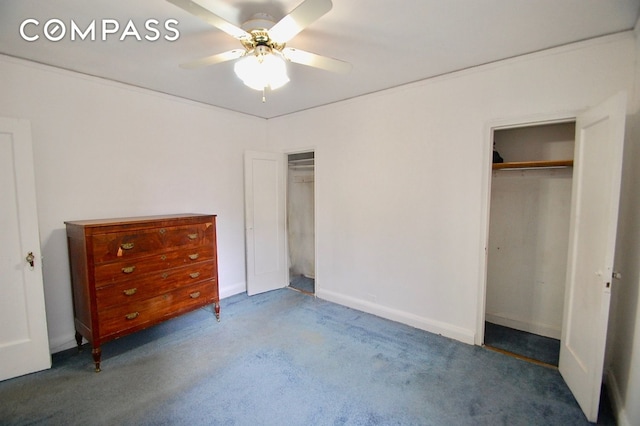 unfurnished bedroom with a ceiling fan, carpet flooring, and two closets