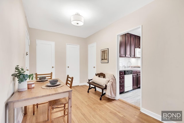 interior space featuring baseboards and light wood-style flooring
