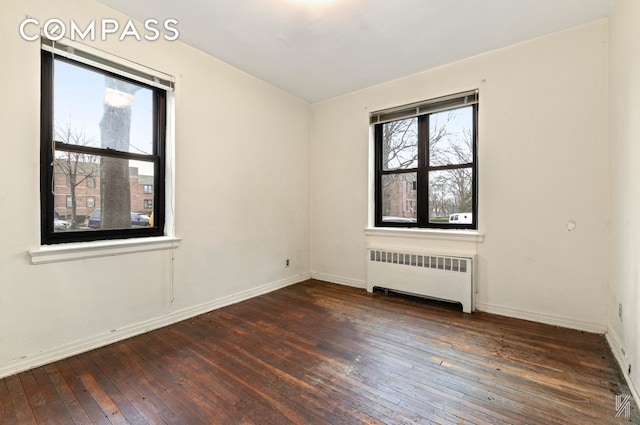 22-60 79th St Unit 1A, New York City, NY 11370 - unfurnished room featuring radiator, wood-type flooring, and baseboards