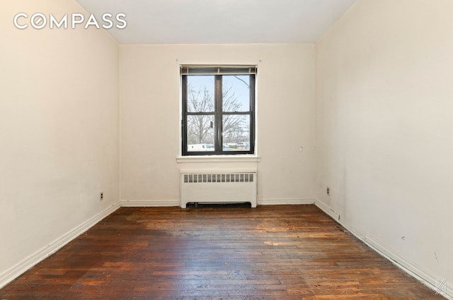22-60 79th St Unit 1A, New York City, NY 11370 - unfurnished room with radiator heating unit, hardwood / wood-style flooring, and baseboards