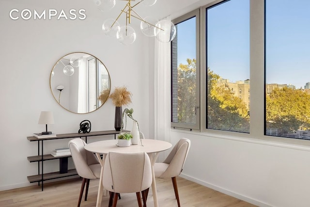 66 Clinton St Unit 5B, New York City, NY 10002 - dining room with light wood finished floors, plenty of natural light, and a chandelier