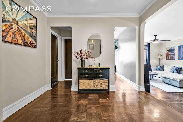 corridor with arched walkways, crown molding, and baseboards