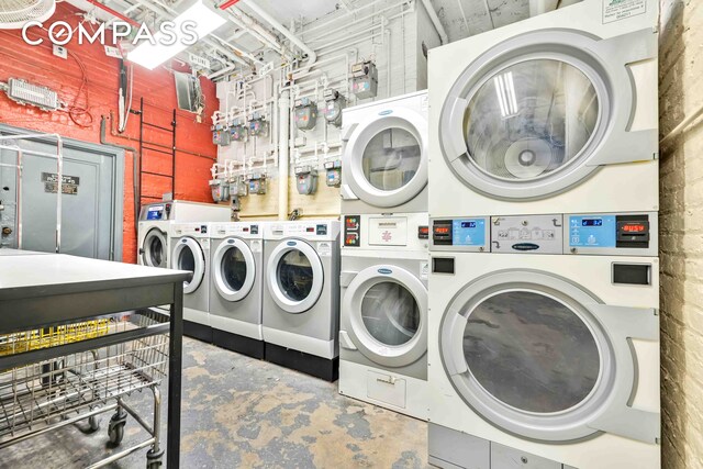 255 W 23rd St Unit 5Gw, New York City, NY 10011 - community laundry room featuring stacked washer and dryer and washing machine and dryer