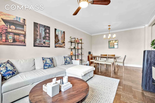 living room featuring ceiling fan with notable chandelier, crown molding, and baseboards