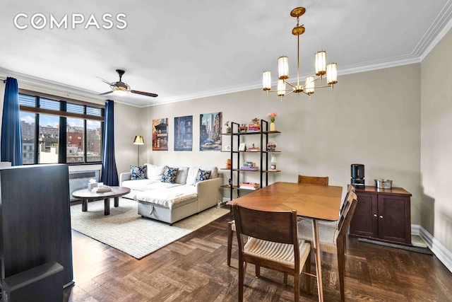 dining room with baseboards, ornamental molding, and ceiling fan with notable chandelier