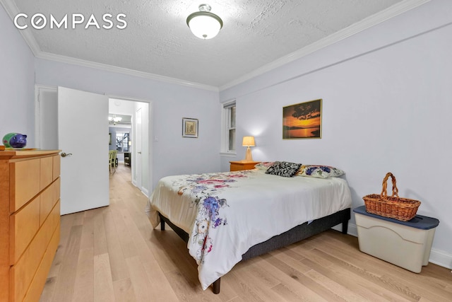 bedroom featuring light wood-style floors, crown molding, and a textured ceiling