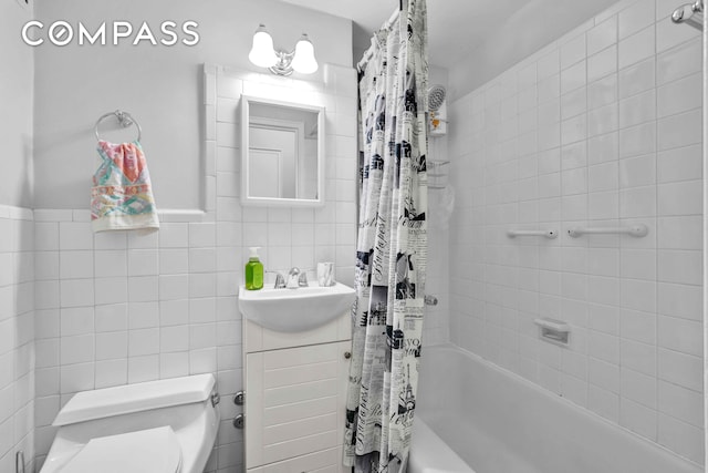 full bath featuring tile walls, vanity, toilet, and shower / tub combo