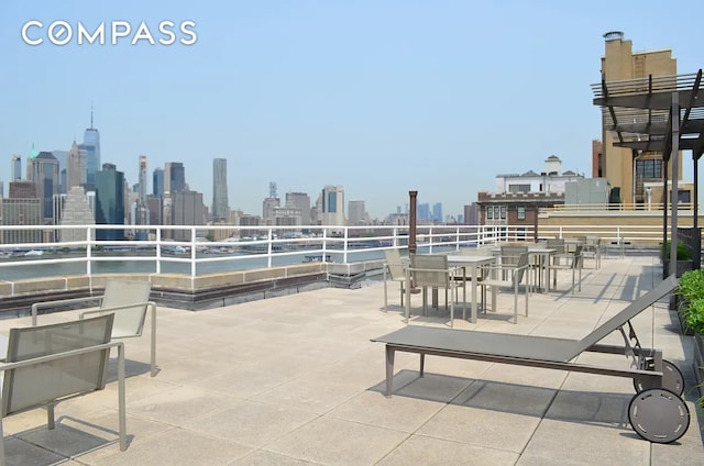 view of patio with a view of city and outdoor dining area