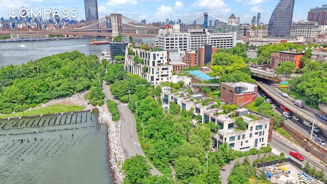 birds eye view of property with a view of city and a water view