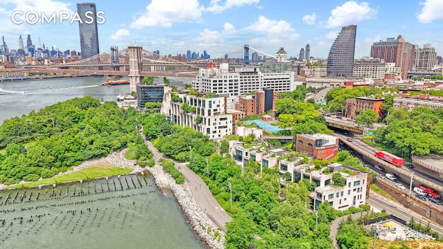 birds eye view of property featuring a water view and a city view