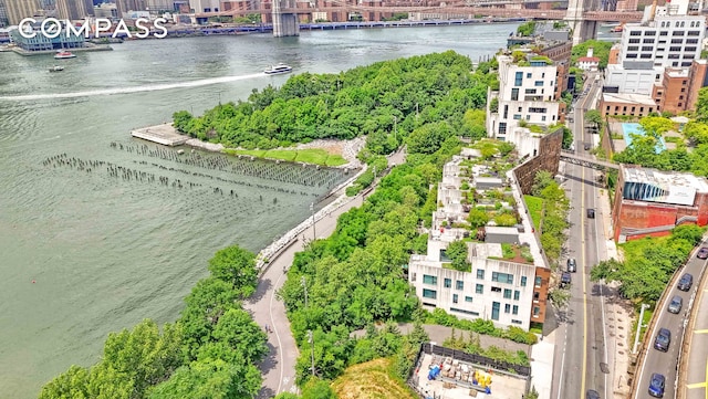 birds eye view of property with a water view and a view of city