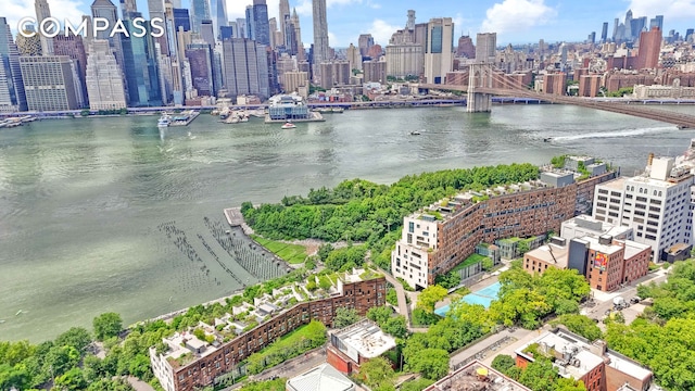 birds eye view of property featuring a water view and a city view