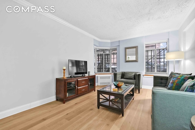 living room with crown molding, a textured ceiling, radiator heating unit, and light wood finished floors
