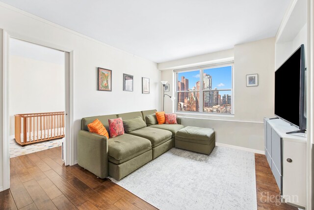 living room with dark wood-type flooring and baseboards