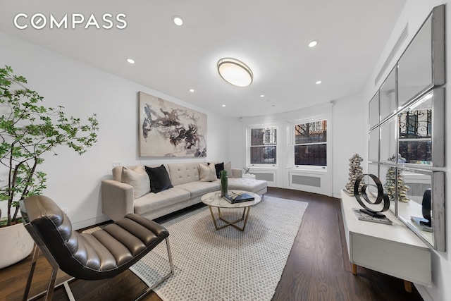 living area featuring dark wood-style flooring and recessed lighting