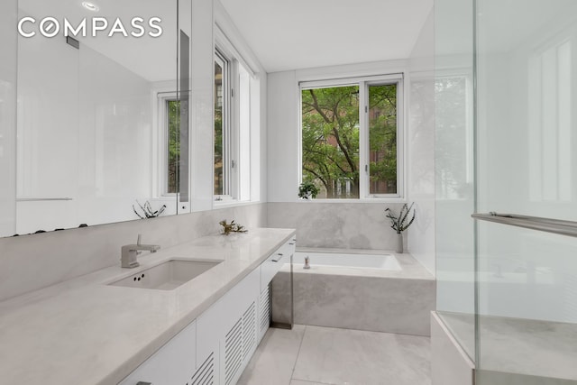 bathroom featuring vanity and a garden tub