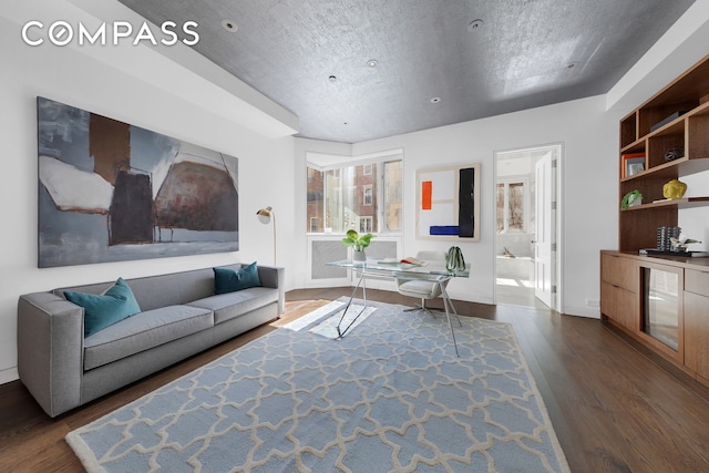 living area with baseboards and dark wood-style floors