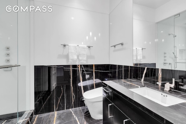 full bath with vanity, toilet, and a stall shower