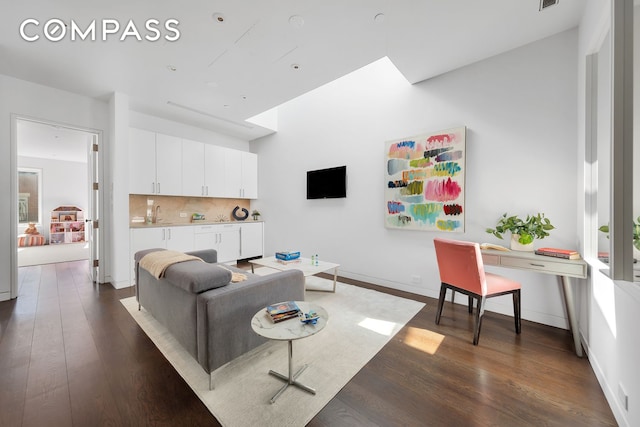 living room with baseboards, dark wood finished floors, and visible vents