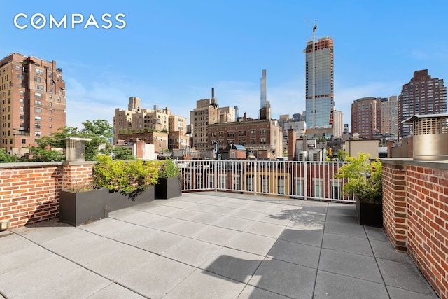 view of patio / terrace featuring a city view