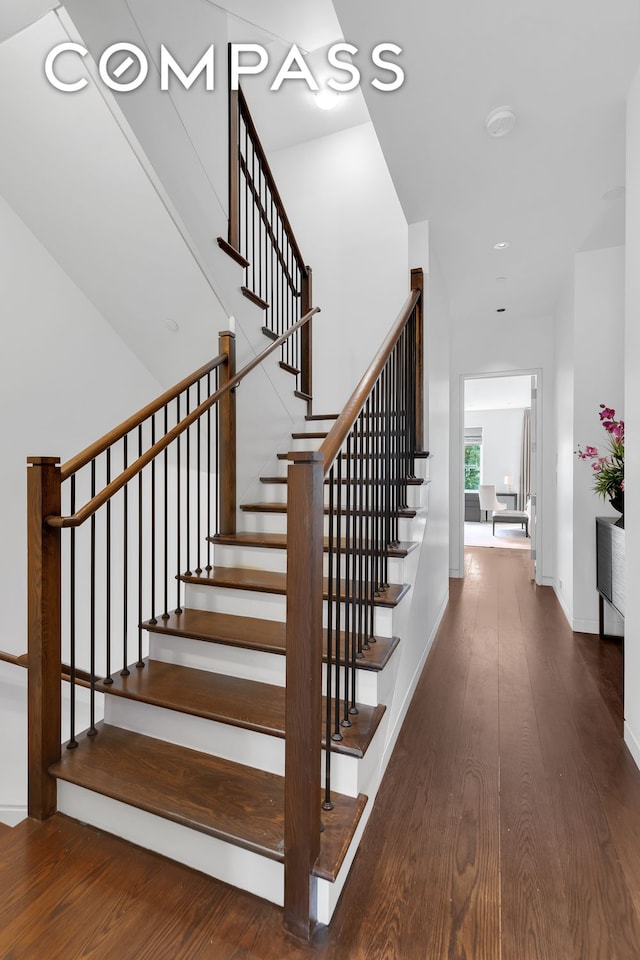 stairs with baseboards and wood finished floors