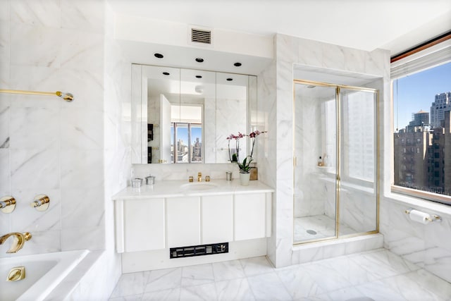 45 E 80th St Unit 17B, New York City, NY 10075 - bathroom featuring a stall shower, tile walls, a city view, vanity, and marble finish flooring