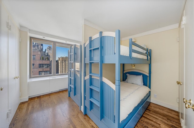 45 E 80th St Unit 17B, New York City, NY 10075 - bedroom featuring wood finished floors, crown molding, and baseboards