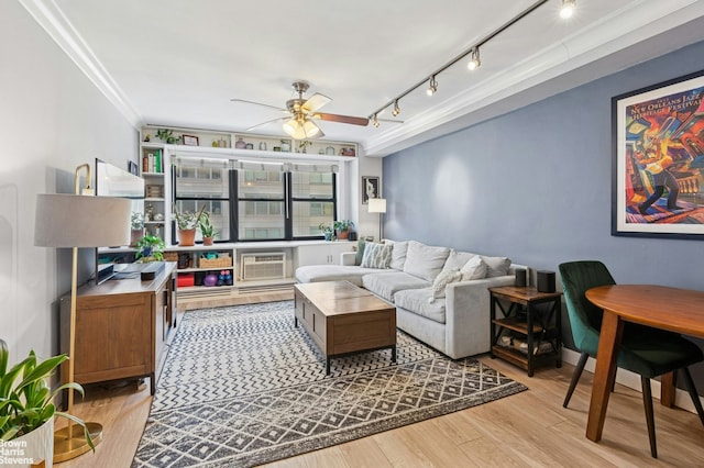 living room featuring a wall mounted AC, track lighting, a ceiling fan, crown molding, and light wood-style floors