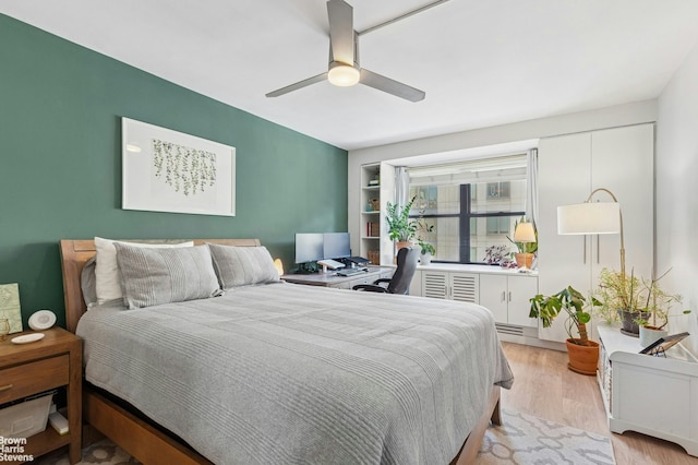 bedroom with light wood finished floors and a ceiling fan