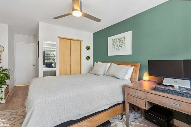 bedroom featuring wood finished floors, a closet, and a ceiling fan