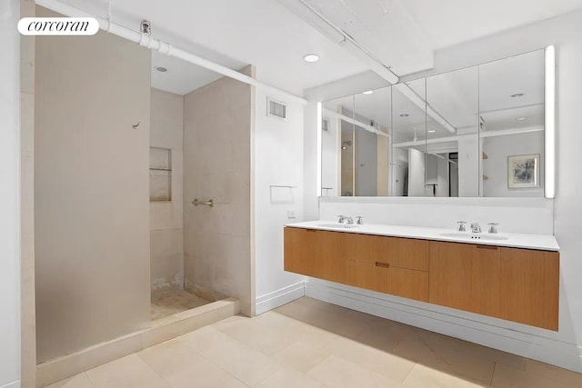 53 Crosby St Unit 1, New York City, NY 10012 - full bath with a tile shower, double vanity, a sink, and visible vents