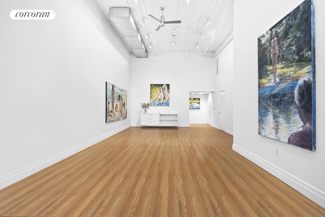 53 Crosby St Unit 1, New York City, NY 10012 - unfurnished living room with wooden ceiling, ceiling fan, baseboards, a towering ceiling, and wood finished floors
