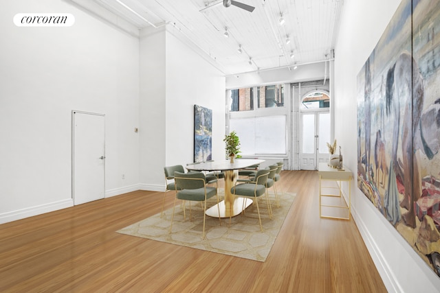 53 Crosby St Unit 1, New York City, NY 10012 - dining room with a high ceiling, track lighting, visible vents, baseboards, and wood finished floors