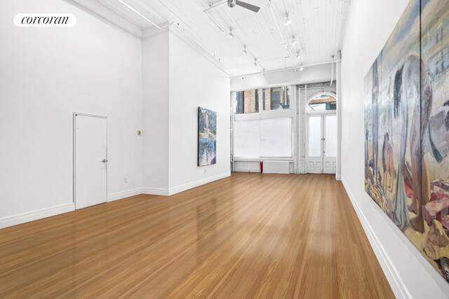 53 Crosby St Unit 1, New York City, NY 10012 - unfurnished room with rail lighting, wood finished floors, visible vents, and baseboards