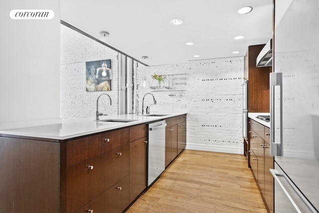 53 Crosby St Unit 1, New York City, NY 10012 - kitchen featuring a sink, light wood finished floors, dishwasher, and light countertops
