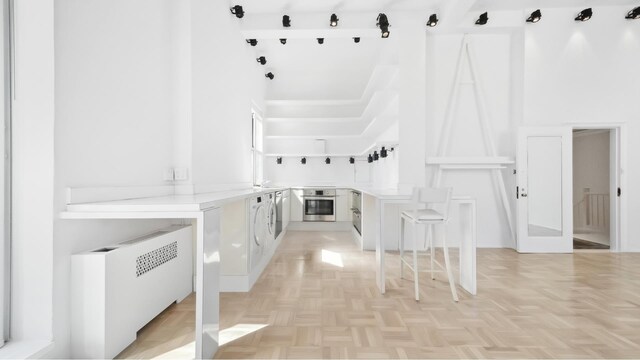 interior space with washer / dryer and radiator
