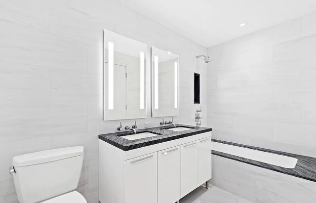 230 E 20th St Unit 11, New York City, NY 10003 - full bathroom featuring toilet, double vanity, and marble finish flooring