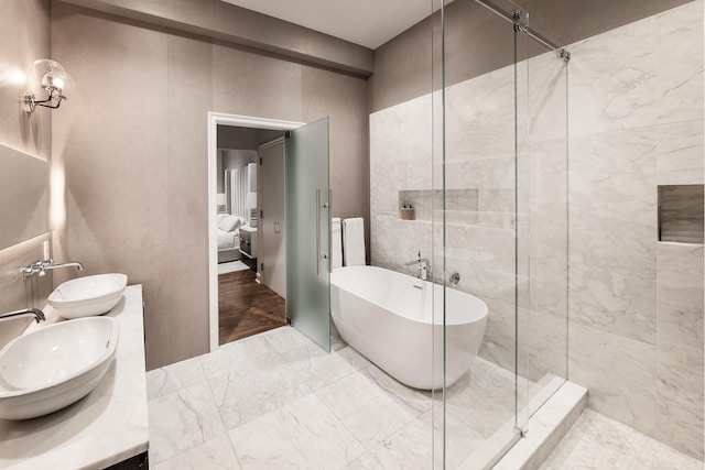 391 Broadway Loftc, New York City, NY 10013 - full bath featuring a soaking tub, ensuite bathroom, double vanity, a stall shower, and marble finish flooring