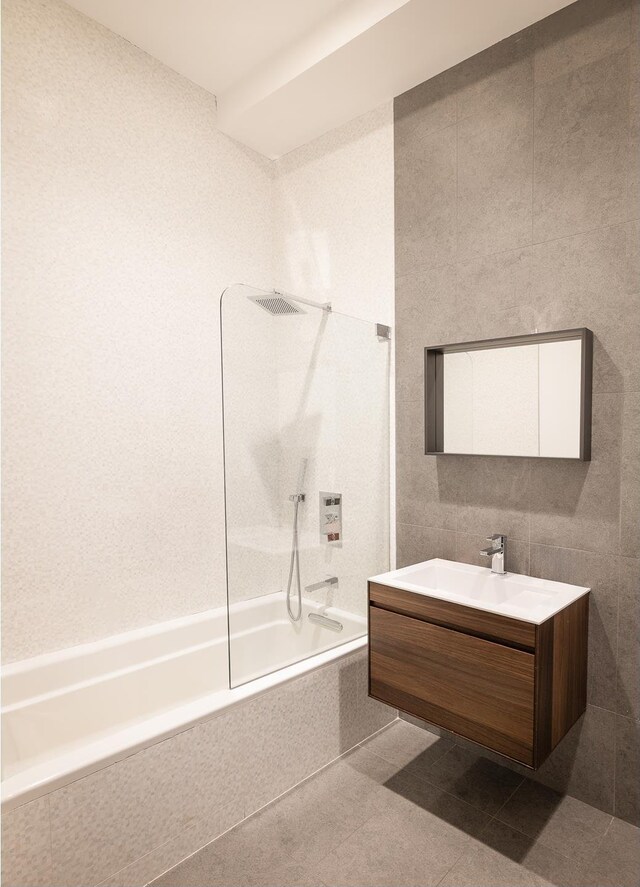 391 Broadway Loftc, New York City, NY 10013 - bathroom with tiled shower / bath combo, vanity, and tile patterned flooring