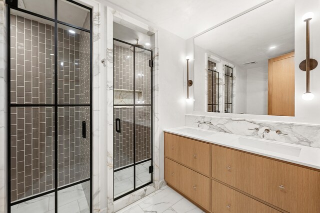 bathroom featuring a shower stall, marble finish floor, and a sink