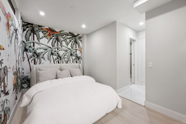 bedroom with baseboards, recessed lighting, and light wood-style floors