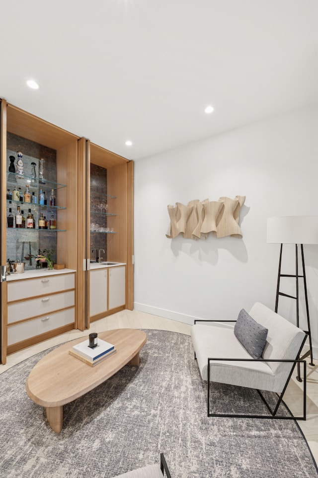 living room featuring recessed lighting and a bar