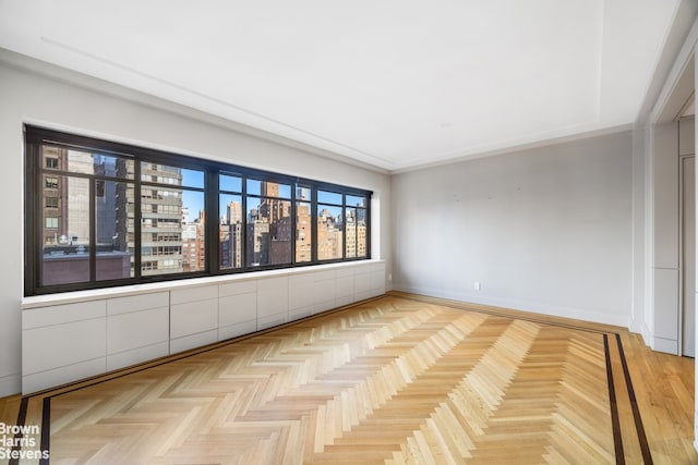 empty room with baseboards and a city view